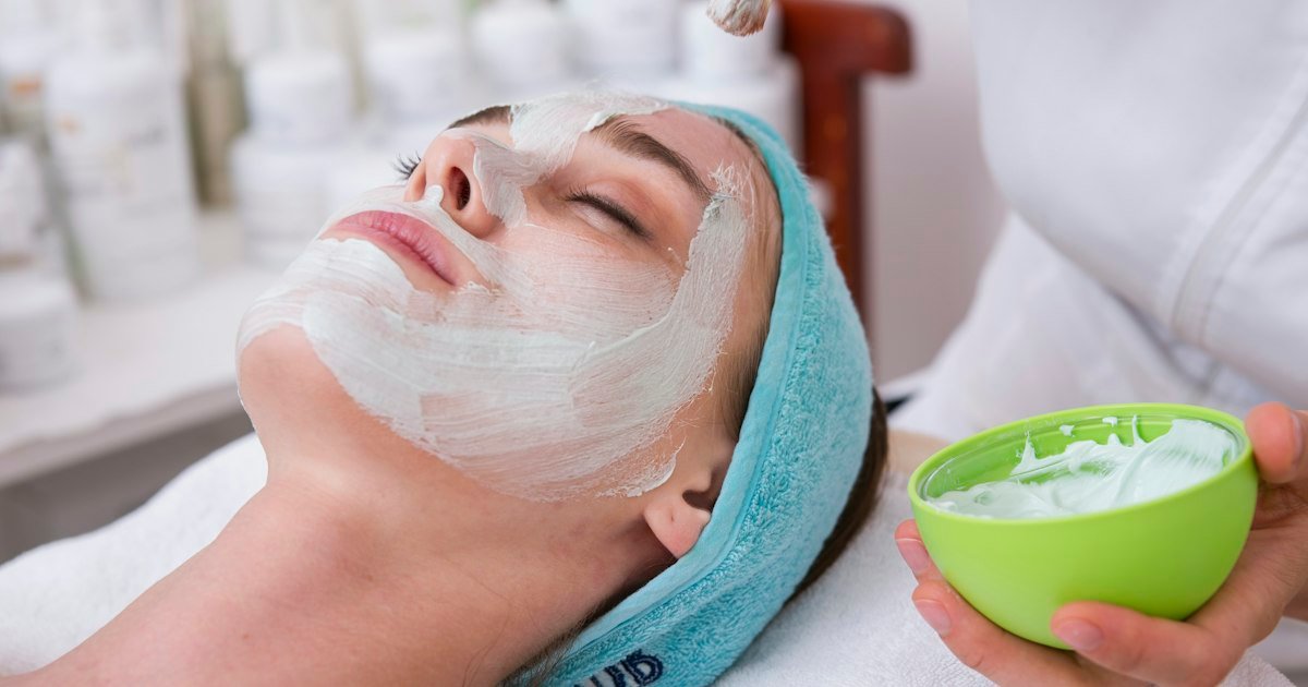 Woman gently applying foaming cleanser to her face during a skincare routine