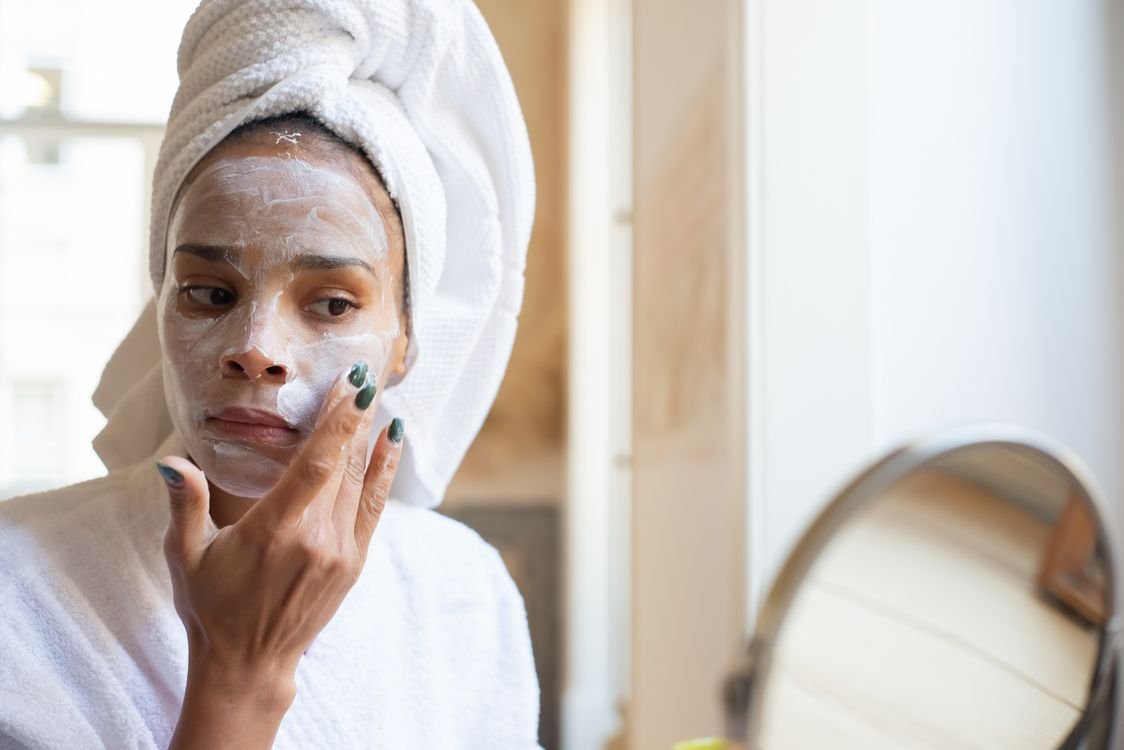 Woman applying moisturising cream as part of a skincare routine