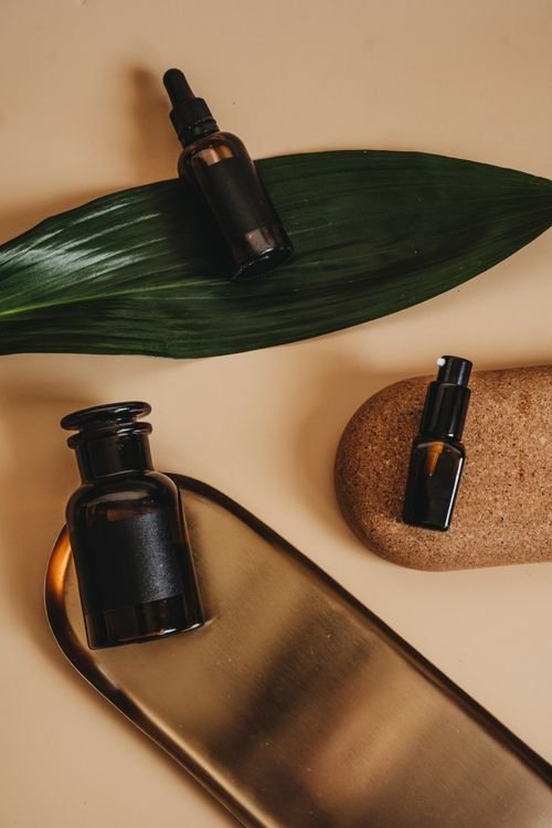 Flatlay of skincare bottles and toner on a neutral background