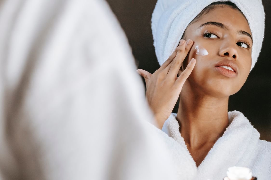 Woman applying cream during her morning skincare routine