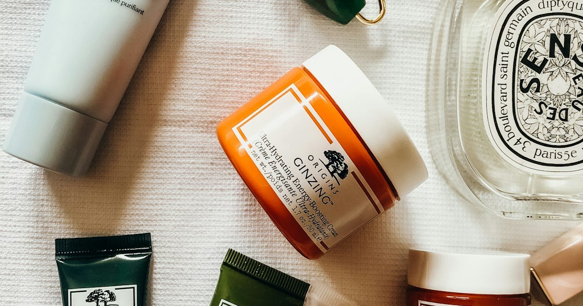 Korean skincare products arranged in a flatlay with glass bottles and cream jars