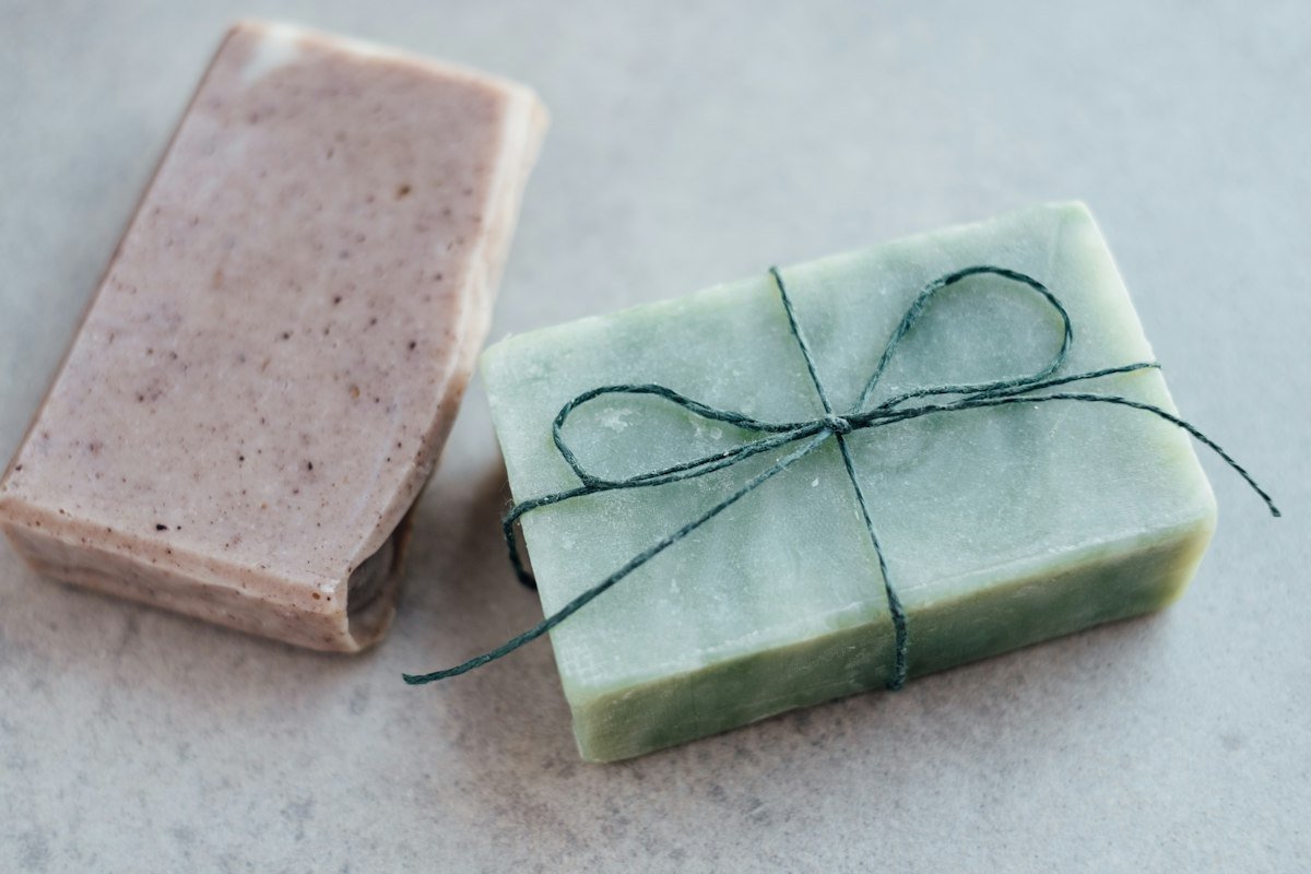 Close-up of a soap bar with natural ingredients beside it