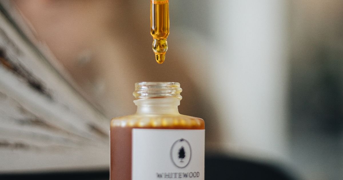 Natural vitamin C face serum bottle with dropper in a clean minimalist setting